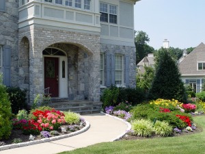 Wider foundation beds mean more plants and more variety, as the Coopers display here in their Hershey front yard.